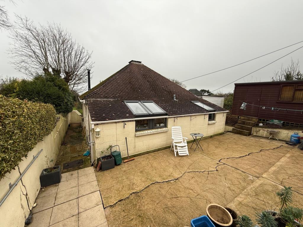 Lot: 128 - DETACHED CHALET-STYLE HOME WITH STRUCTURAL MOVEMENT ON A PLOT OF 0.17 ACRE - A view of the property from the road side